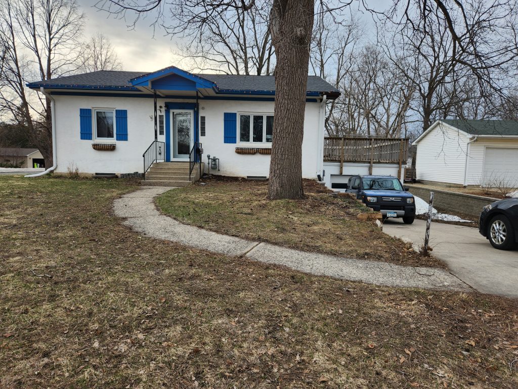 A one-story white and blue house