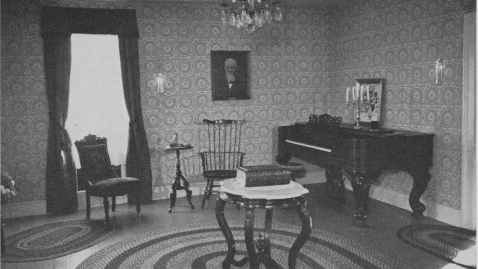 Black and white photo of the parlor inside the Alexander Faribault House. 